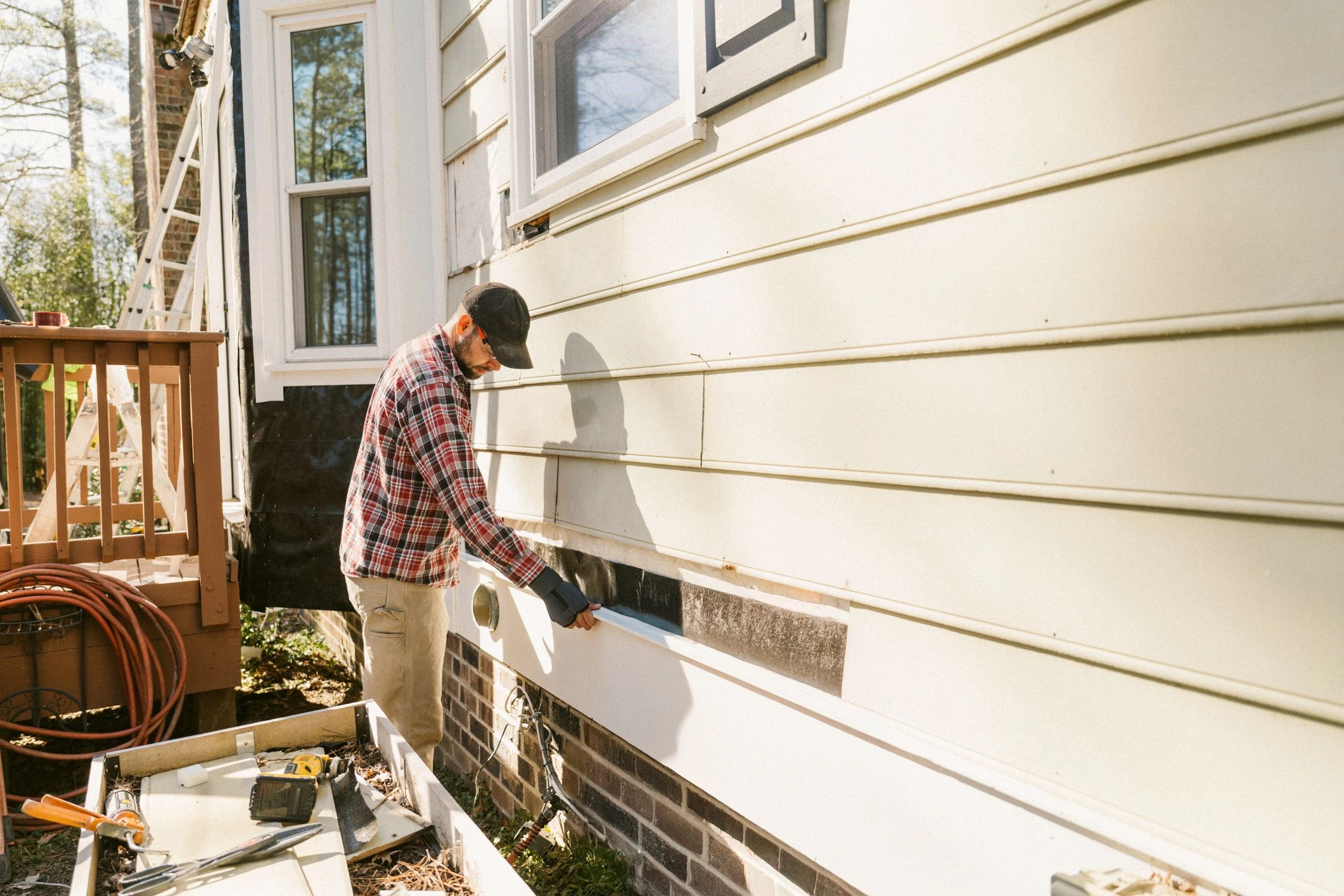 Home service professional working on residential exterior